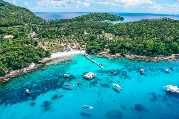 One of the best islands in Phuket, Racha as seen from helicopter as boats approach the popular bay arrival area