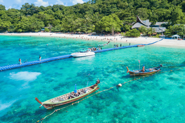 the crystal clear blue waters at banana beach as seen from above