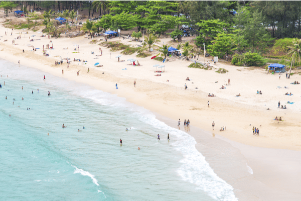 nai harn beach during the day as seen from helicopter