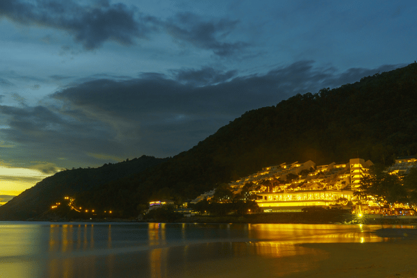 the nai harn hotel as seen from the water at night