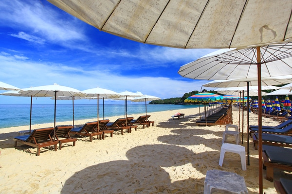 a line of sunbeds empty, along the foreshore at nai yang phuket