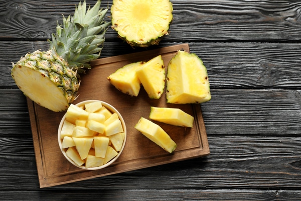 a sliced pineapple on a cutting board